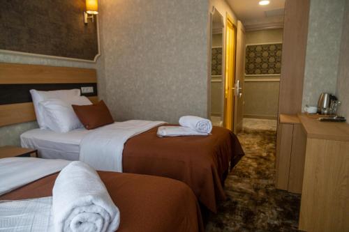 a hotel room with two beds with towels on them at Hotel Solum Roof Top in Tbilisi City