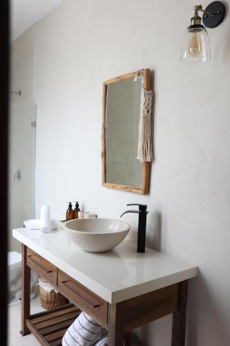 a bathroom with a sink and a mirror on a counter at AGAM Hotel Boutique Bacalar - Adults Only in Bacalar