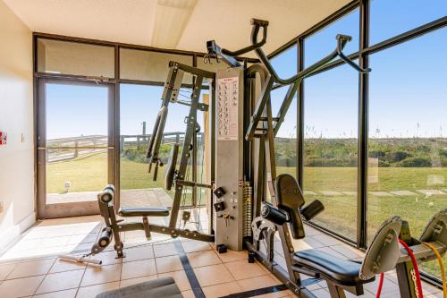 a gym with two tread machines and a large window at Destin on the Gulf in Destin