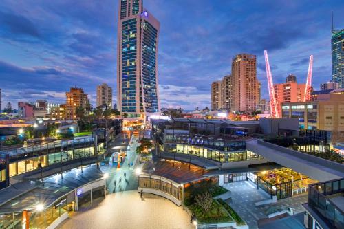 a city skyline at night with a tall building at Circle on Cavill Surfers Paradise- 3 Bedroom SPA Apartment in Gold Coast