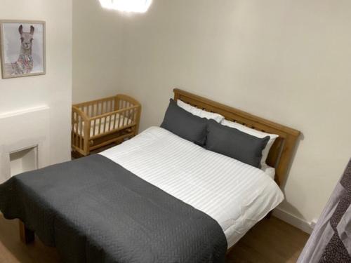 a bedroom with a bed and a crib at Ideal Abode Greenfields in Chester