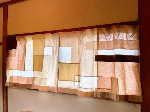 a curtain on a window in a room at 淡路島 サササウナ in Awaji