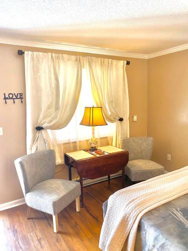 a bedroom with a bed and a table and chairs at Grafton Lodge in Lake Lure