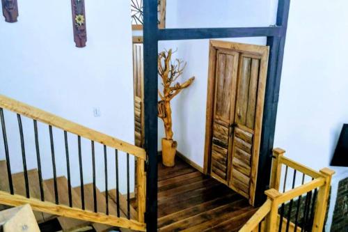 a wooden staircase with a wooden door and a plant at El Encanto Mountain Cabin in Salento
