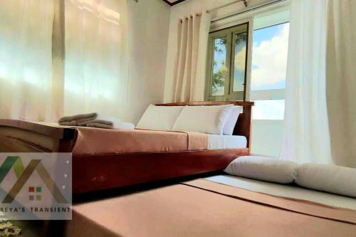 a bedroom with a bed and a window at Mireya's 1BR condo at Zone Vill - Burnham Park in Baguio
