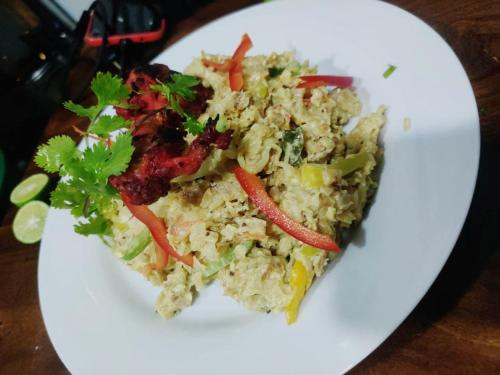 a white plate of food with rice and vegetables at Anukama Resort in Nilaveli