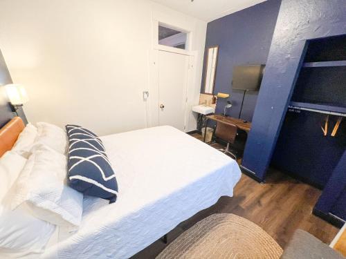 a bedroom with a white bed and a desk at ITH San Diego Mission Beach Backpacker Hostel in San Diego
