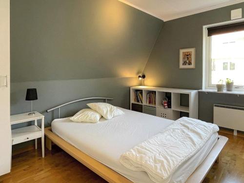 a bedroom with a white bed and a window at Holiday home TORSLANDA III in Torslanda