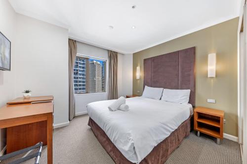 a hotel room with a bed with a teddy bear on it at Comfy One Bedroom Apartment In Heart of The Rocks in Sydney