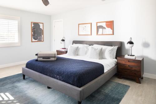 a bedroom with a large bed with a blue blanket at Indigo By AvantStay Sleek Charming Home 2 Blks from Bay w Hot Tub in San Diego