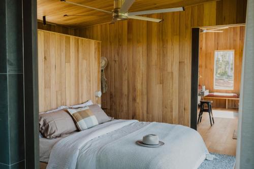 a bedroom with a bed and a ceiling fan at Upland Farm Luxury Cabins, Denmark Western Australia in Denmark