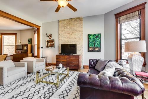 a living room with a couch and a tv at Garage Parking - Vintage Charm - and a Fabulous Location! Easily Enjoy the Best of Chicago! in Chicago