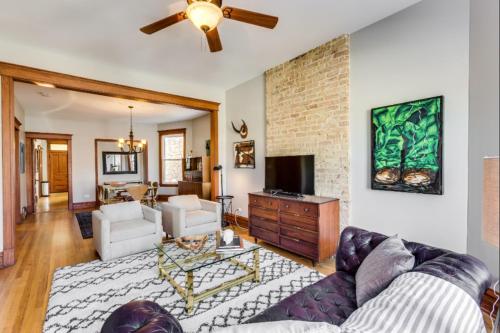 a living room with a couch and a brick wall at Garage Parking - Vintage Charm - and a Fabulous Location! Easily Enjoy the Best of Chicago! in Chicago