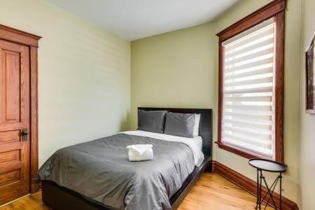 a bedroom with a large bed with a window at Garage Parking - Vintage Charm - and a Fabulous Location! Easily Enjoy the Best of Chicago! in Chicago