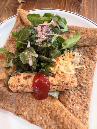 a white plate with two slices of bread with a salad at Vegetarian House Jamoo in Yamanakako