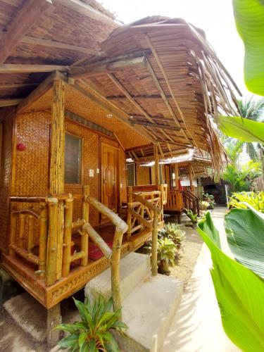 a bamboo house with a large roof at Jake and Zyra Place in San Vicente