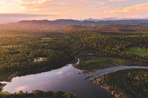 an aerial view of a river and forests at Jackson Ranch by Bannisters in Bawley Point