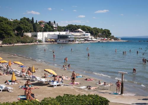 a group of people on a beach in the water at Apartment Mario in Split
