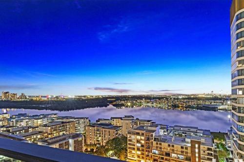 a view of a city with buildings and a body of water at New Luxury stunning water view 2bed2bath Condo in Sydney
