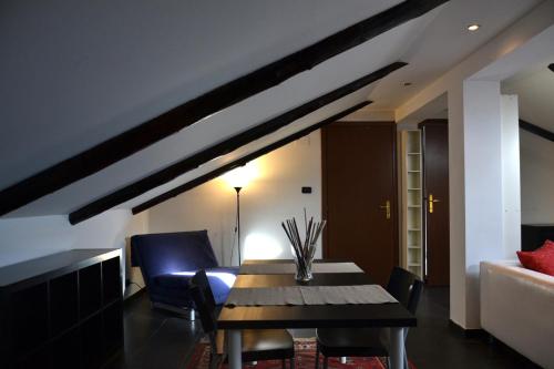 a living room with a wooden table and chairs at Olimpico in Turin