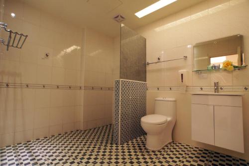 a bathroom with a toilet and a shower at Taitung Venice B&B in Taitung City