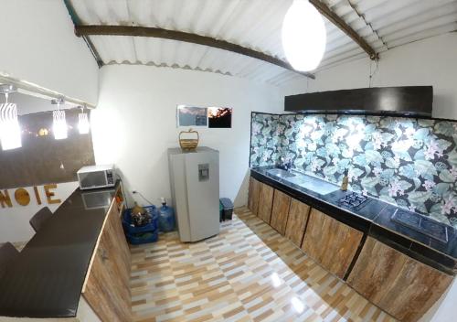 a kitchen with a large aquarium in a room at Akainoie in Minca