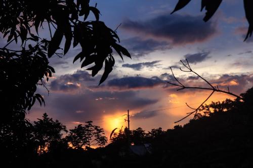 a sunset in the sky with at Akainoie in Minca