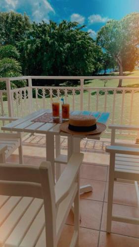 a white table with a cake and two chairs at Studio Premium Vue Mer, Plage in Sainte-Luce