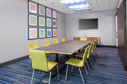 a conference room with a wooden table and yellow chairs at Holiday Inn Express - Wells-Ogunquit-Kennebunk by IHG in Wells