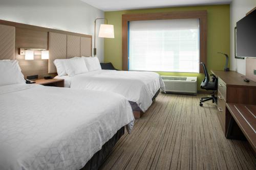 a hotel room with two beds and a television at Holiday Inn Express - Wells-Ogunquit-Kennebunk by IHG in Wells