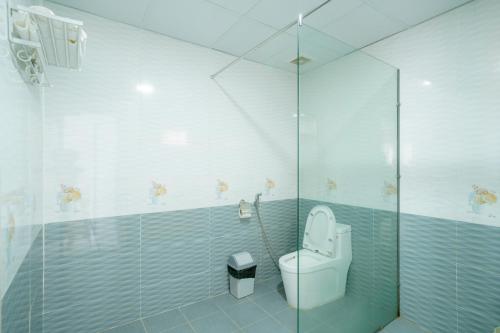 a bathroom with a toilet and a glass shower at Thai Tan Tien Hotel in Phu Quoc