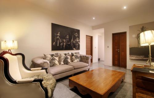 a living room with a couch and a coffee table at The Apartments Canggu in Canggu