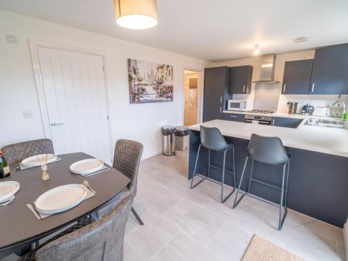 a kitchen and dining room with a table and chairs at Modern 3-Bed Home with Garden & Free Parking - Pass the Keys in Nottingham
