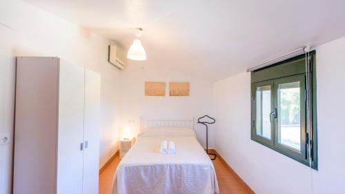a small bedroom with a bed and a window at Almenara Los Corrales by Ruralidays in Martín de la Jara
