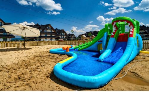 a water slide in the sand on a beach at Apartament w Białce Tatrzańskiej in Białka Tatrzańska