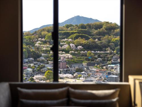 a view of a city from a window at THE BLOSSOM KUMAMOTO in Kumamoto