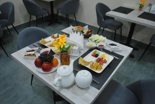 a table with plates of food on it at Airport Hotel 24 in Tashkent