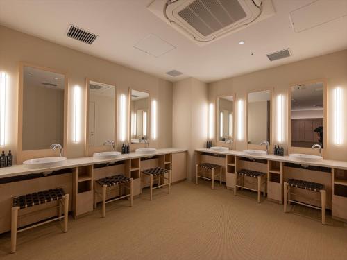 a large bathroom with four sinks and mirrors at THE BLOSSOM KUMAMOTO in Kumamoto