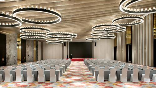 a conference room with rows of chairs and chandeliers at Crowne Plaza Quanzhou Riverview by IHG in Quanzhou