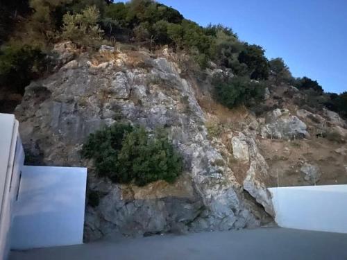 a rocky hill with trees on top of it at MARINOS House WANDERN&ENTSPANNEN am Fusse des Psiloritis in Kamárai