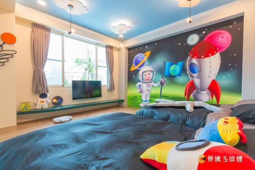 a childrens room with two beds and a tv at Longer Homestay in Taitung City