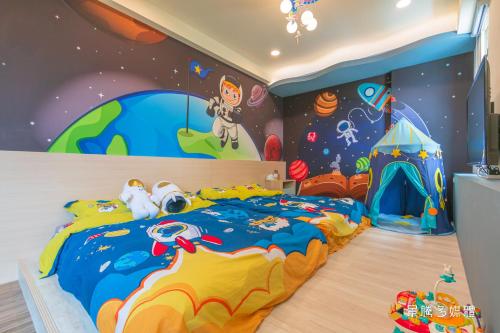 a childs room with a bed with a cartoon theme at Longer Homestay in Taitung City