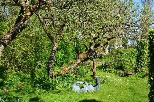 a statue of a goose sitting in the grass near trees at Wonderland in Pieterburen