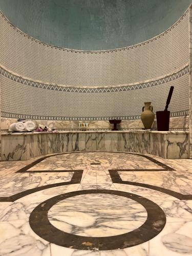 a room with a large stone floor with a vase at Royal Hotel Oran - MGallery Collection in Oran