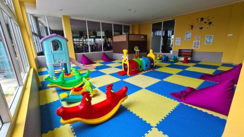 a childrens play room with toys on the floor at Grand Sunshine Resort & Convention in Bandung