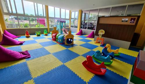 a childs play area with toys on the floor at Grand Sunshine Resort & Convention in Bandung