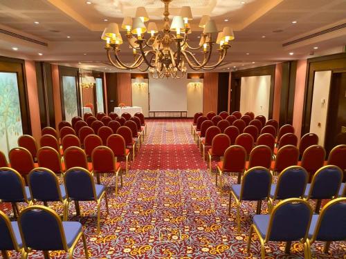 a conference room with chairs and a table in it at Royal Hotel Oran - MGallery Collection in Oran