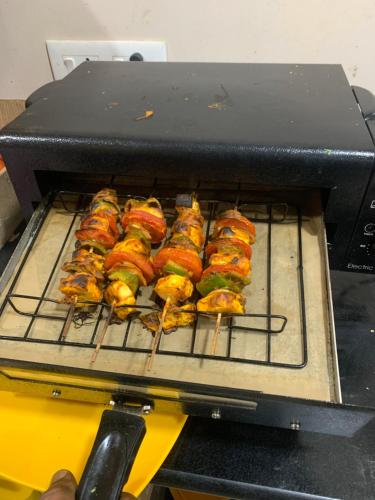 a grill with a bunch of food on it at Bogar Palace Kodaikanal in Kodaikānāl