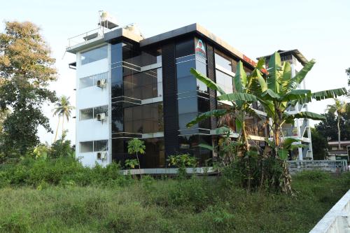 a building with a lot of plants in front of it at Airport Cochin Grand Residency , NEDUMBASSERY in Angamaly