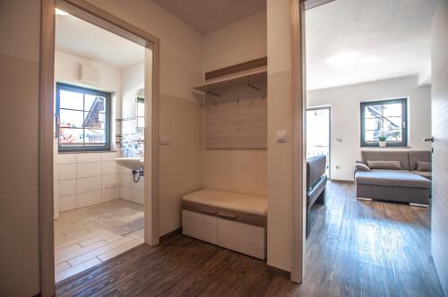 a bathroom with a sink and a couch in a room at Apartments Francka in Bohinj